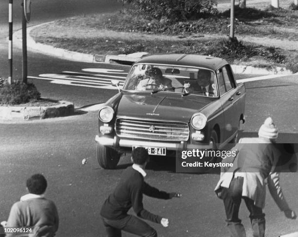 Black youths stoning a car during unrest in Athlone, Cape Town, South Africa, 16th September 1976. The violence comes in the wake of the Soweto...