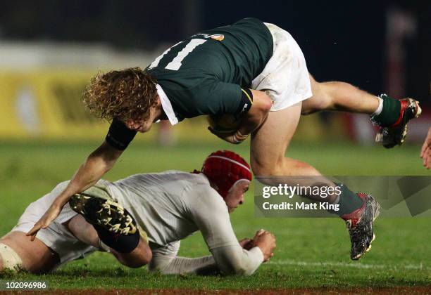 Nick Cummins of the Barbarians is tackled by Dave Attwood of England during the match between the Australian Barbarians and England at Bluetongue...