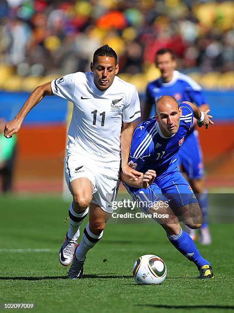 Leo Bertos of New Zealand and Robert Vittek of Slovakia tussle for the ball during the 2010 FIFA World Cup South Africa Group F match between New...