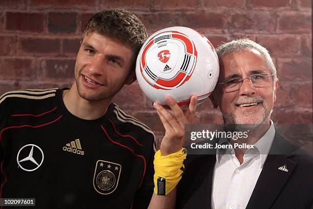 Thomas Mueller of Germany and former german football player Gerd Mueller are pictured with the first official ball, "Torfabrik" for the german...