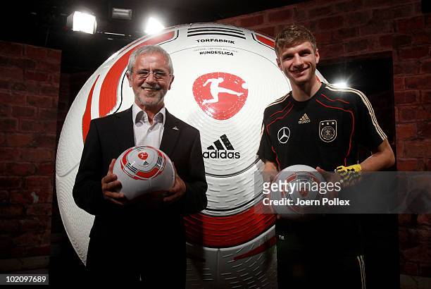 Thomas Mueller of Germany and former german football player Gerd Mueller are pictured with the first official ball, "Torfabrik" for the german...