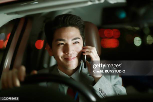 businessman talking on smartphone in car - management car smartphone stock-fotos und bilder