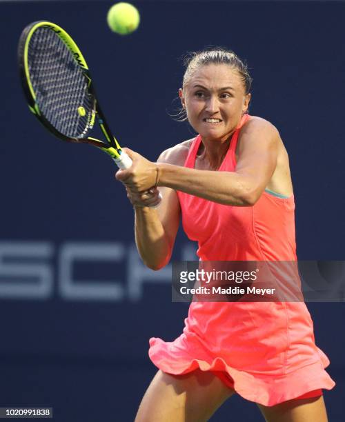 Aliaksandra Sasnovich of Belarus returns a shot to Caroline Garcia of France during Day 2 of the Connecticut Open at Connecticut Tennis Center at...