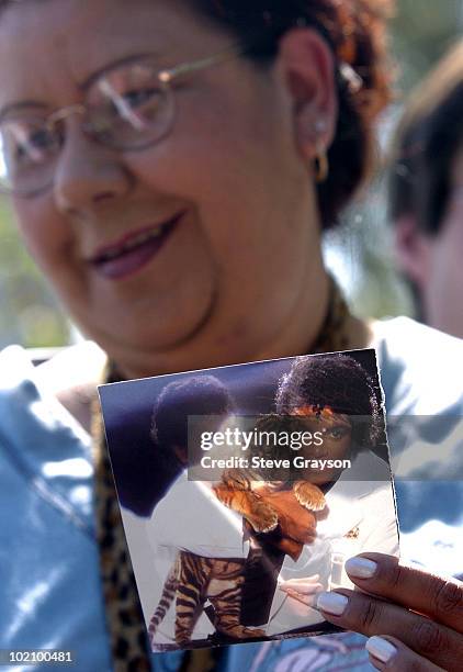 Michael Jackson fan holds a cover of Jackson's album "Thriller" outside the gates Michael Jackson's Neverland Ranch in Los Olivos, California after...