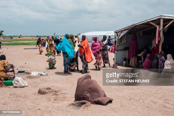 Woman sits on the ground at an IDP camp in Pulka on August 1, 2018. - As the presidential race heats up ahead of February polls, the Nigerian...
