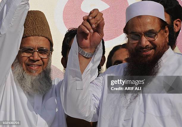 Hafiz Saeed , leader of banned charity organisation Jamaat-ud-Dawa, and Munawar Hasan , head of the Islamic political party Jamaat-e-Islam, raises...