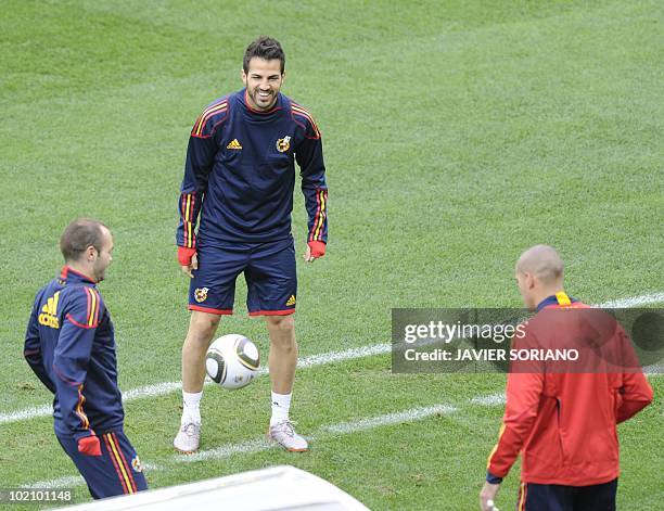Spain's midfielder Cesc Fabregas Spain's goalkeeper Victor Valdes and Spain's midfielder Andrés Iniesta take part in a official training session at...