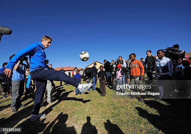 Michael Dawson plays football with kids from the SOS Children's Village on June 15, 2010 in Rustenburg, South Africa.