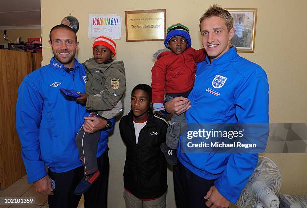 Michael Dawson and Matthew Upson pose with children from the SOS Children's Village project on June 15, 2010 in Rustenburg, South Africa.