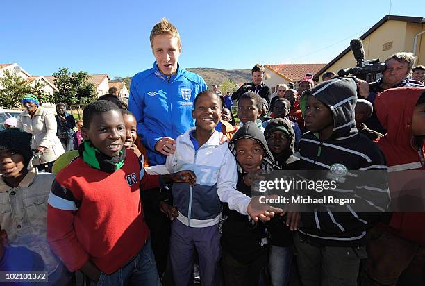 Michael Dawson poses with children from the SOS Children's Village project on June 15, 2010 in Rustenburg, South Africa.