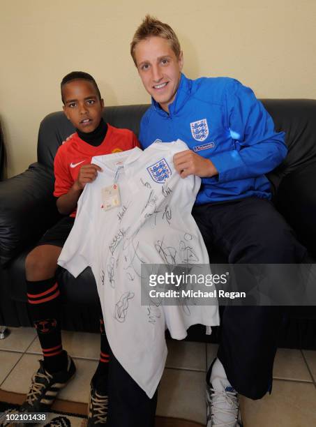 Michael Dawson presents a signed England shirt to Aubrey from the SOS Children's Village on June 15, 2010 in Rustenburg, South Africa.