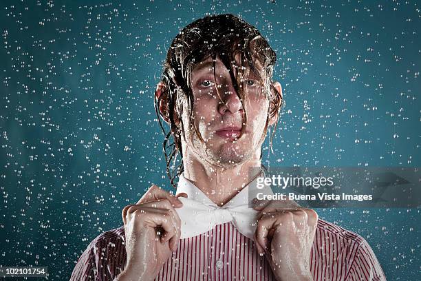 young man in rain - wetter imagens e fotografias de stock