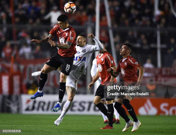 Pablo Hernandez of Independiente heads for the ball with Alison of Santos during a round of sixteen match between Independiente and Santos as part of...