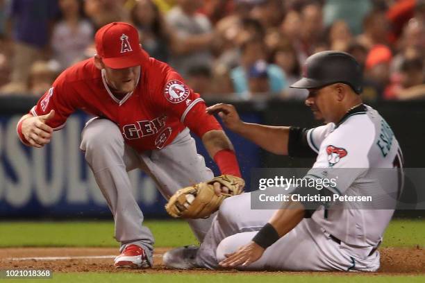 Infielder Taylor Ward of the Los Angeles Angels tags out Eduardo Escobar of the Arizona Diamondbacks as he slides into third base during the third...