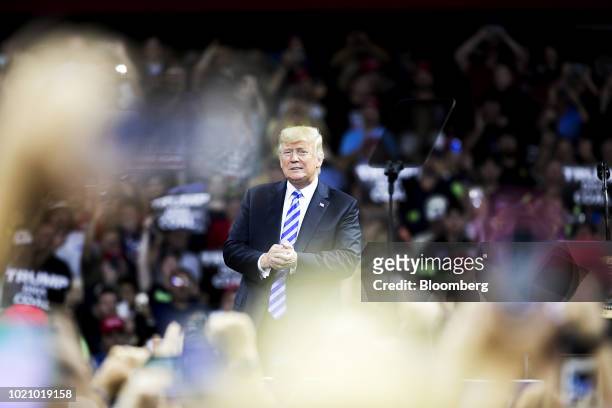 President Donald Trump stands during a rally in Charleston, West Virginia, U.S., on Tuesday, Aug. 21, 2018. Trump called the conviction of his former...
