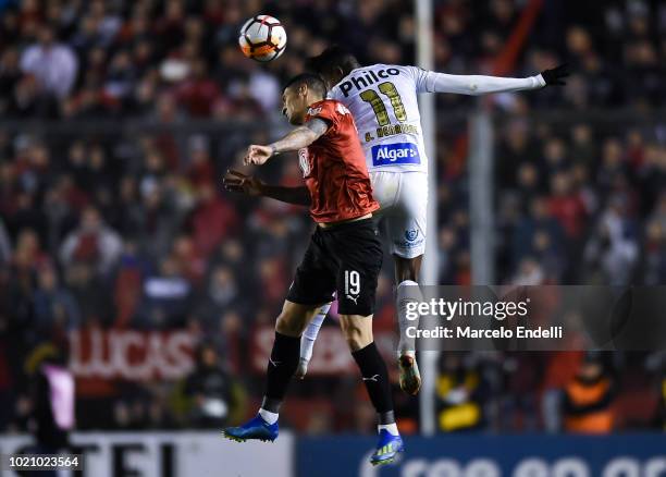 Bruno Hernrique of Santos heads for the ball with Pablo Hernandez of Independiente during a round of sixteen match between Independiente and Santos...