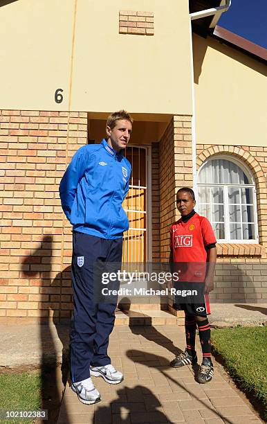 Michael Dawson stands with Aubrey outside a home in the SOS Children's Village project on June 15, 2010 in Rustenburg, South Africa.