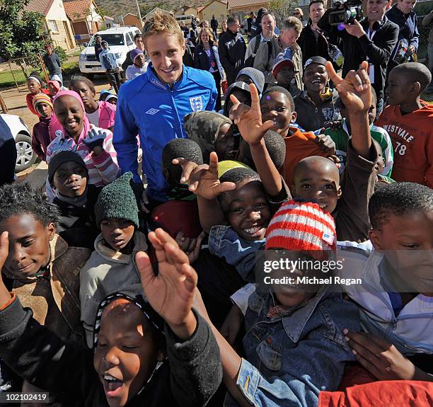 Michael Dawson poses with a child from the SOS Children's Village project on June 15, 2010 in Rustenburg, South Africa.