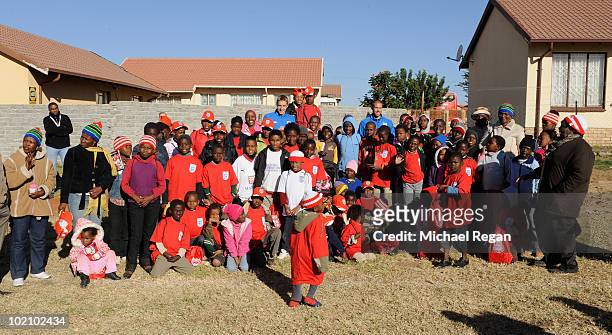 Michael Dawson and Matthew Upson pose with children from the SOS Children's Village project on June 15, 2010 in Rustenburg, South Africa.