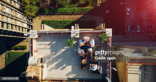 senior friends having fun on rooftop - building terrace stock pictures, royalty-free photos & images