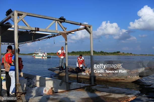 Contractors working for BP head out to work on the oil spill June 15, 2010 in Grand Isle, Louisiana. The BP spill has been called the largest...