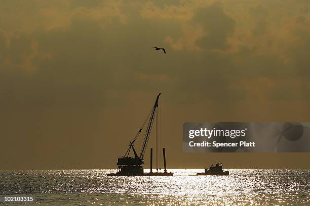 Dredger is pulled out to sea for work on the oil spill June 15, 2010 in Grand Isle, Louisiana. The BP spill has been called the largest environmental...
