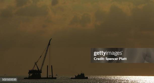 Dredger is pulled out to sea for work on the oil spill June 15, 2010 in Grand Isle, Louisiana. The BP spill has been called the largest environmental...