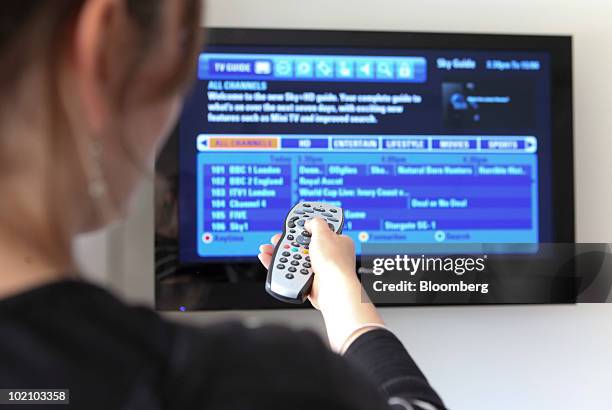 Woman uses a Sky remote control in Romford, U.K., on Tuesday, June 15, 2010. British Sky Broadcasting Plc, the U.K.'s largest pay-TV provider,...