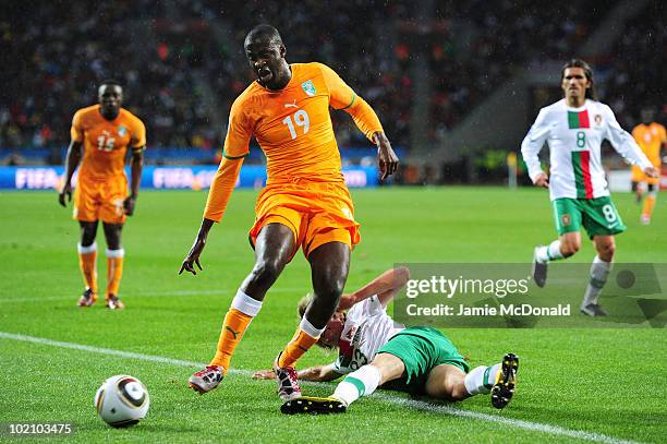 Yaya Toure of Ivory Coast is tackled by Fabio Coentrao of Portugal during the 2010 FIFA World Cup South Africa Group G match between Ivory Coast and...