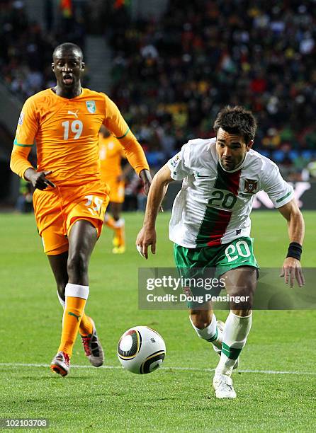 Yaya Toure of Ivory Coast pursues Deco of Portugal during the 2010 FIFA World Cup South Africa Group G match between Ivory Coast and Portugal at...