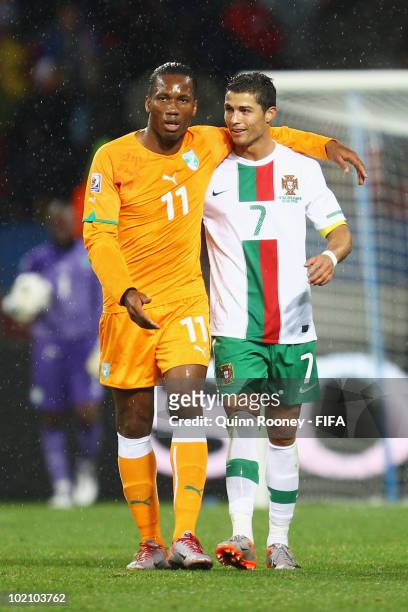 Didier Drogba of Ivory Coast puts his arm around Cristiano Ronaldo of Portugal during the 2010 FIFA World Cup South Africa Group G match between...
