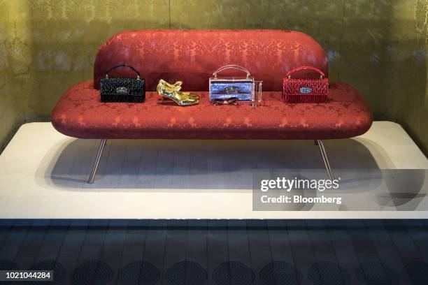 Handbags and shoes are displayed in the window of a luxury store in the Omotesando area of Tokyo, Japan, on Tuesday, Aug. 21, 2018. Japan is...