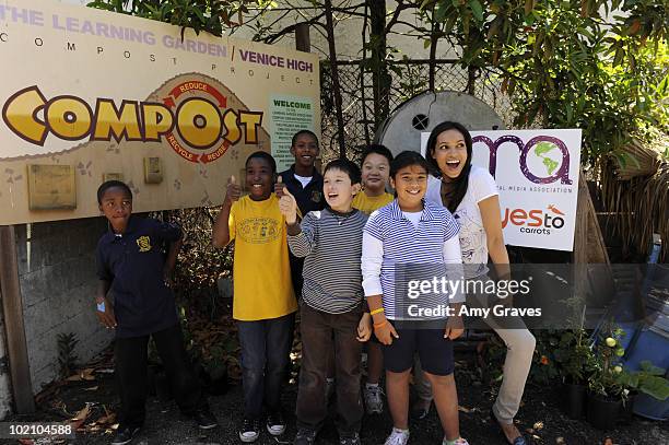 Actress Rosario Dawson poses for photos with children at the Environmental Media Association and Yes to Carrots Garden Luncheon at The Learning...