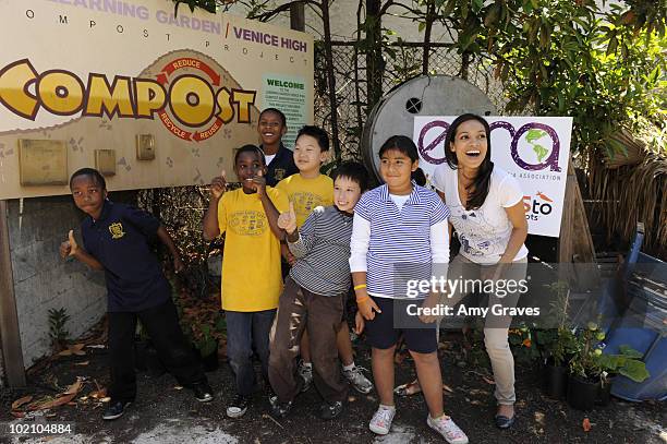 Actress Rosario Dawson poses for photos with children at the Environmental Media Association and Yes to Carrots Garden Luncheon at The Learning...