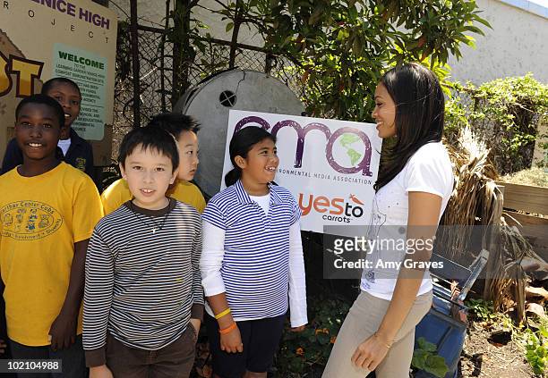 Actress Rosario Dawson poses for photos with children at the Environmental Media Association and Yes to Carrots Garden Luncheon at The Learning...