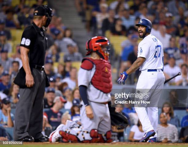 Matt Kemp of the Los Angeles Dodgers argues a strikeout looking call with umpire Jim Wolf between Yadier Molina of the St. Louis Cardinals during the...
