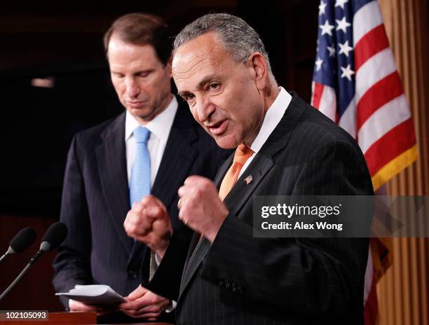 Sen. Charles Schumer speaks as Sen. Ron Wyden listens during a news conference June 15, 2010 on Capitol Hill in Washington, DC. The senators called...