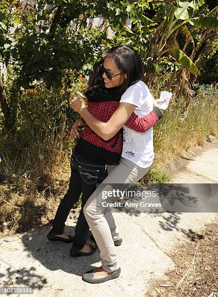 Actress Rosario Dawson greets a child attending the Environmental Media Association and Yes to Carrots Garden Luncheon at The Learning Garden at...