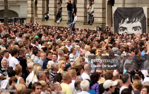 Banner depicting Jackie Duddy, a victim of the Bloody Sunday shootings, is seen above the crowd outside the Guildhall during the announcement into...