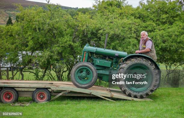 Man reverses his vintage Fordson tractor from a trailer during Rosedale Show on August 18, 2018 in Kirkbymoorside, England. Founded in 1871, this...