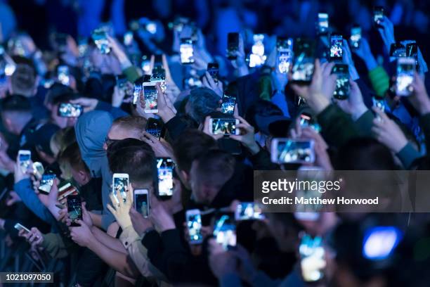 Spectators hold up mobile phones at an event on May 2, 2018 in Cardiff, United Kingdom.