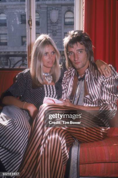 British musician Rod Stewart and his girlfriend, Swedish actress Britt Ekland, sits on a sofa in a hotel room while on a promotional tour in support...