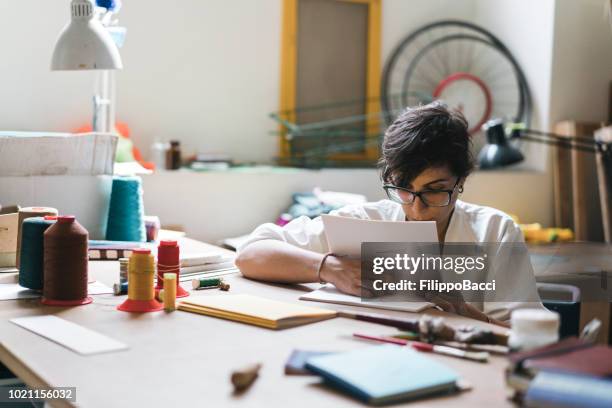 young adult woman making a notebook - book binding stock pictures, royalty-free photos & images