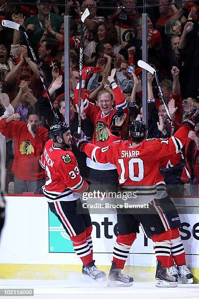 Dustin Byfuglien and Patrick Sharp of the Chicago Blackhawks celebrate scoring a goal against the Philadelphia Flyers in Game Five of the 2010 NHL...