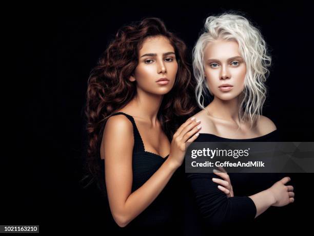 photo of two beautiful girls - blonde hair black background stock pictures, royalty-free photos & images