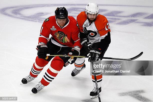 Marian Hossa of the Chicago Blackhawks skates against Simon Gagne of the Philadelphia Flyers in Game Five of the 2010 NHL Stanley Cup Final at the...