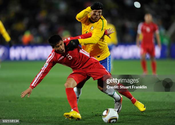 Luis Fabiano of Brazil is tackled by Ri Kwang-Chon of North Korea during the 2010 FIFA World Cup South Africa Group G match between Brazil and North...