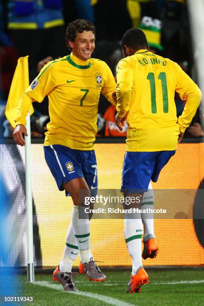 Elano of Brazil celebrates with team mate Robinho after he scores his side's second goal during the 2010 FIFA World Cup South Africa Group G match...