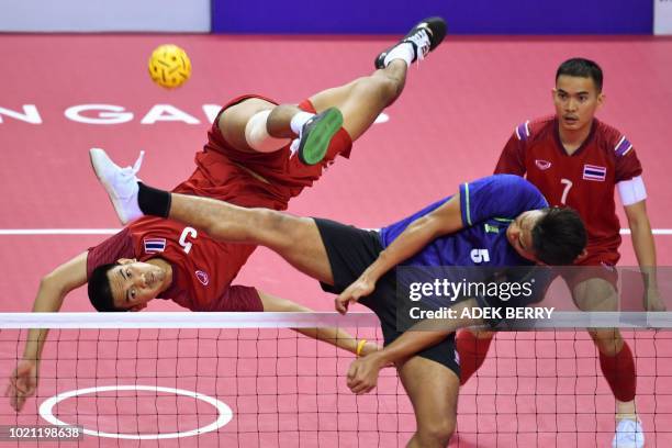 Thailand's Pornchai Kaokaew kicks the ball as Malaysia's Mohamad Azlan Alias tries to block in the men's team regu final between Thailand and...