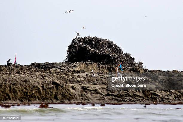 Mud flies through the air as sand dredge work continues to rebuild part of a barrier island east of Grande Terre Island, Louisiana, U.S., on Tuesday,...